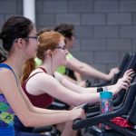 two-women-walking-treadmills