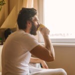 CET pic man drinking coffee in bed shutterstock_558862594