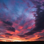 Beautiful dramatic sunset over Styrian land in Austria. Colorful winter evening on countryside.